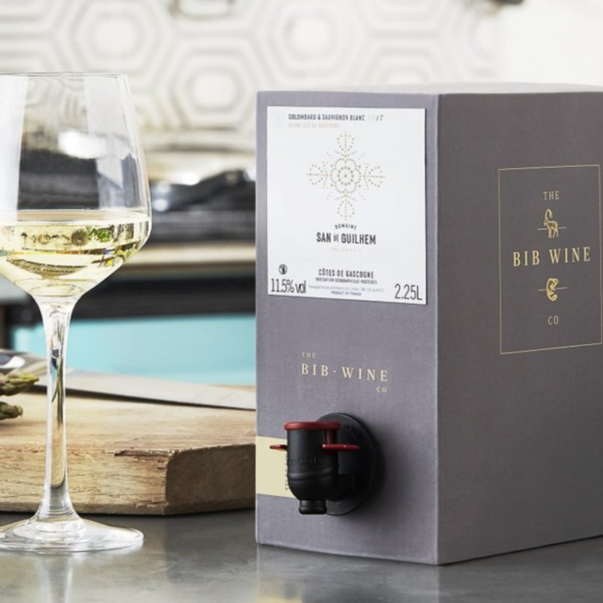 Boxed BIB wine on countertop with a glass of wine standing next to it