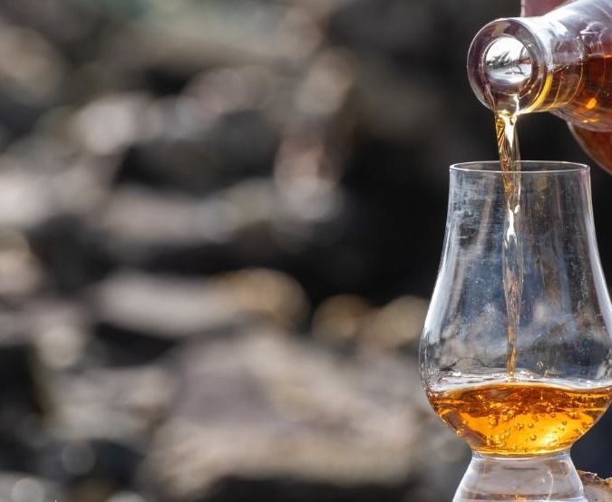 pouring whisky into a glass