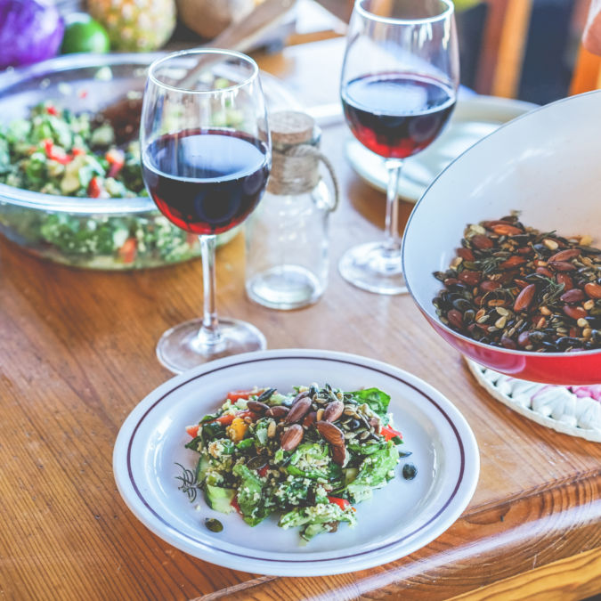 Male chef serving organic vegan salad for dinner