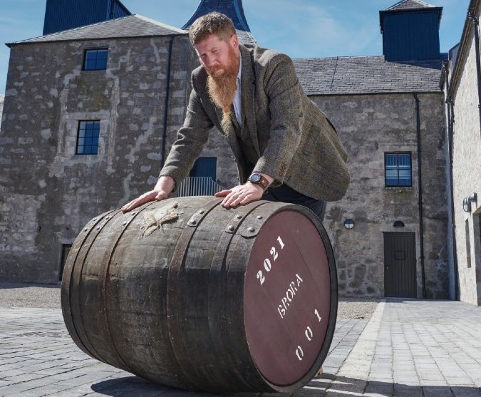 stewart bowman rolling a barrel at brora distillery