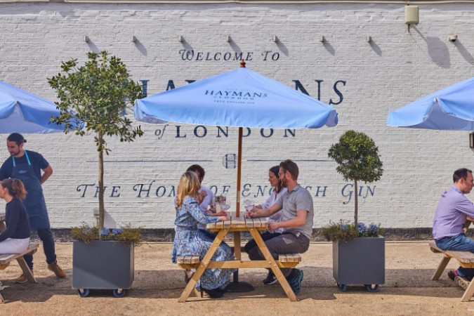 hayman's gin distillery garden with drinkers