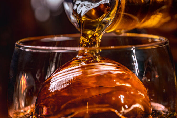 ice cube over whisky