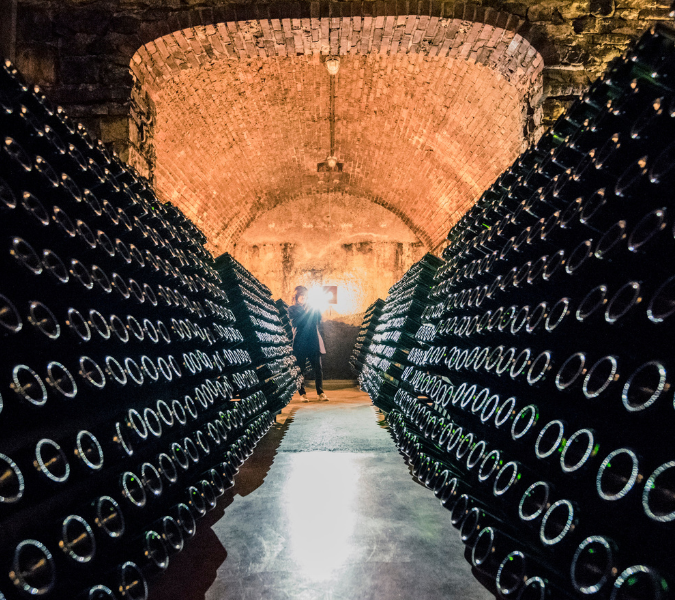 Rows and rows of bottles lees ageing in an underground cellar in Franciacorta