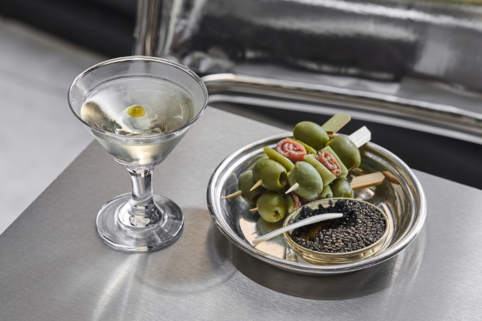 A Martini cocktail with a dish of gildas and caviar at new restaurant Noisy Oyster