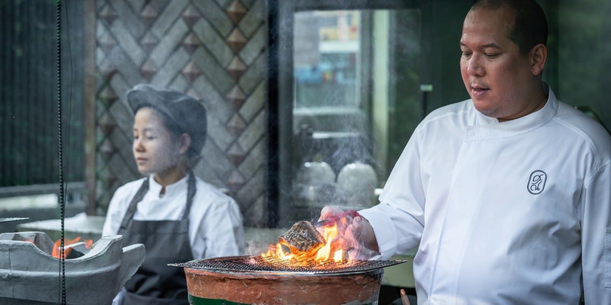 Two chefs working in the kitchen at Sorn restaurant in Bangkok