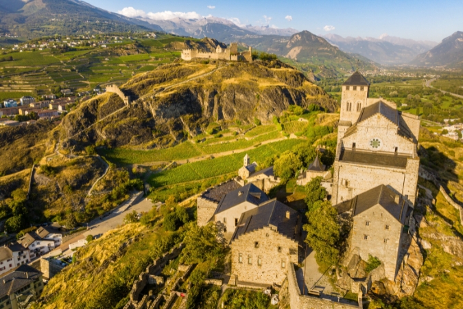 A scenic view of the vineyards and ancient architecture of the Provins, one of the best wineries in Switzerland to visit for tours and tastings
