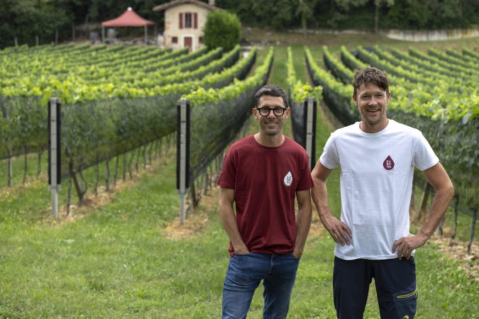 Two of the members of the Fa'Wino team stand for a picture in front of the vines