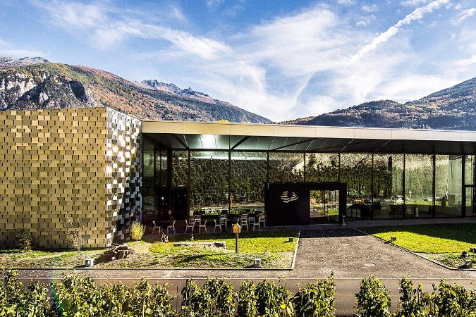 The facade of the modern Les Celliers de Sion winery in Switzerland