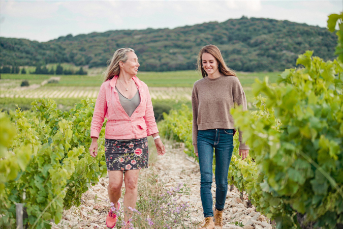 A pair of women walking amongst vines at Domaine de la Mordoree