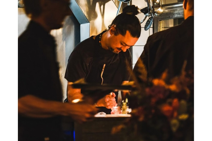 A chef prepares good at Brasserie Uno, one of the best Swiss restaurants in the Valais region