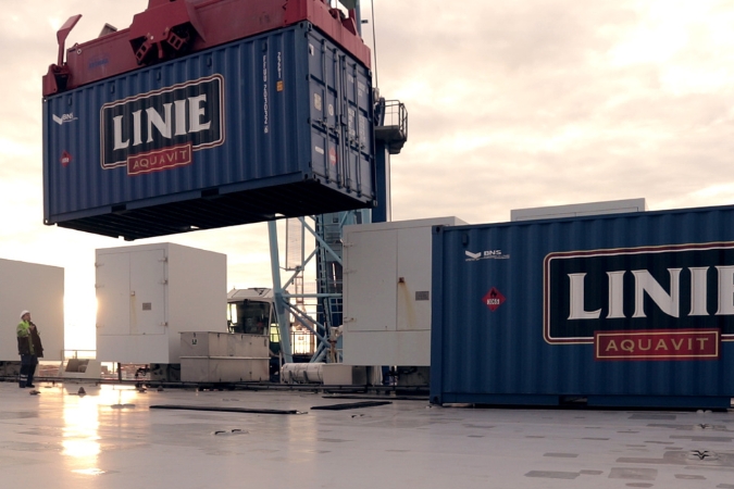 Shipping containers with Linie aquavit inside at a port