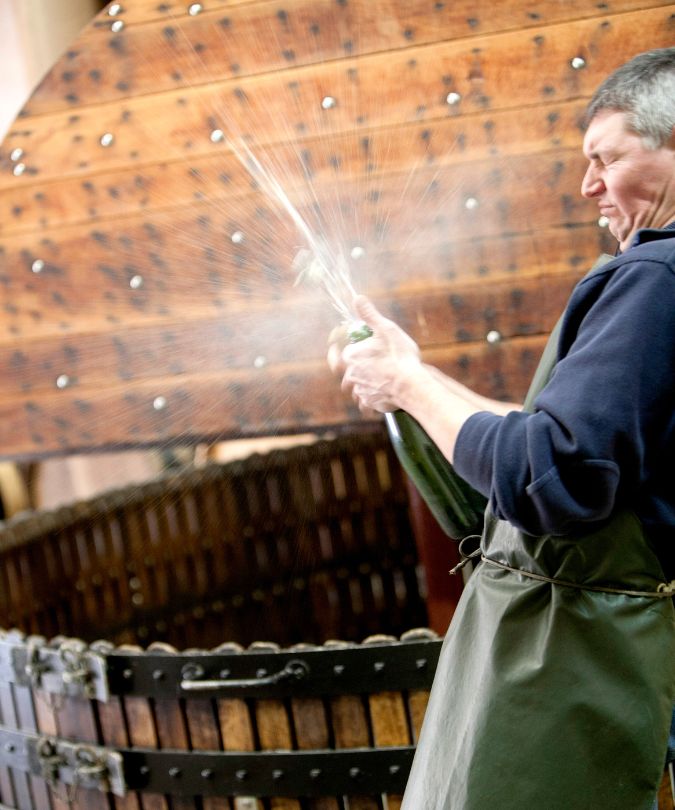 Vigneron Emmanuel Lassaigne disgorges a bottle at Jacques Lassaigne