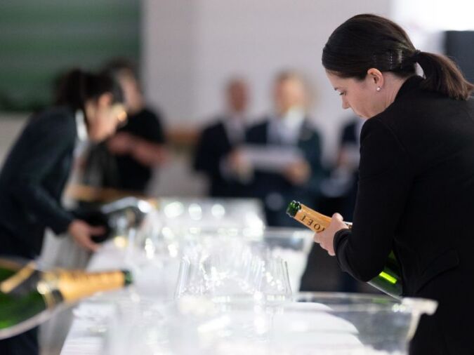sommelier emma denney pouring wine at uk sommelier of the year competition