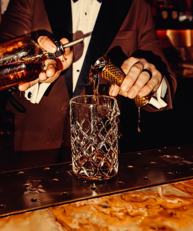 mixing cocktails at the bar at The Pinky Ring in Las Vegas