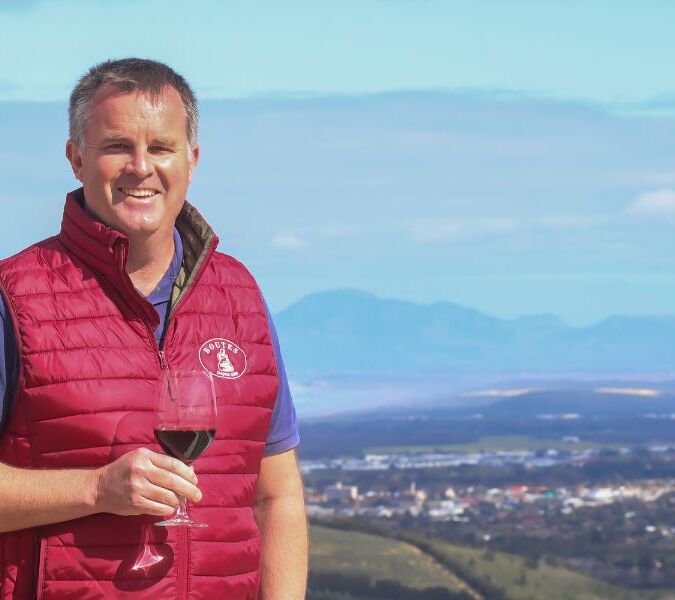 winemaker luke o'cuinneagain with glass of red wine at viewpoint