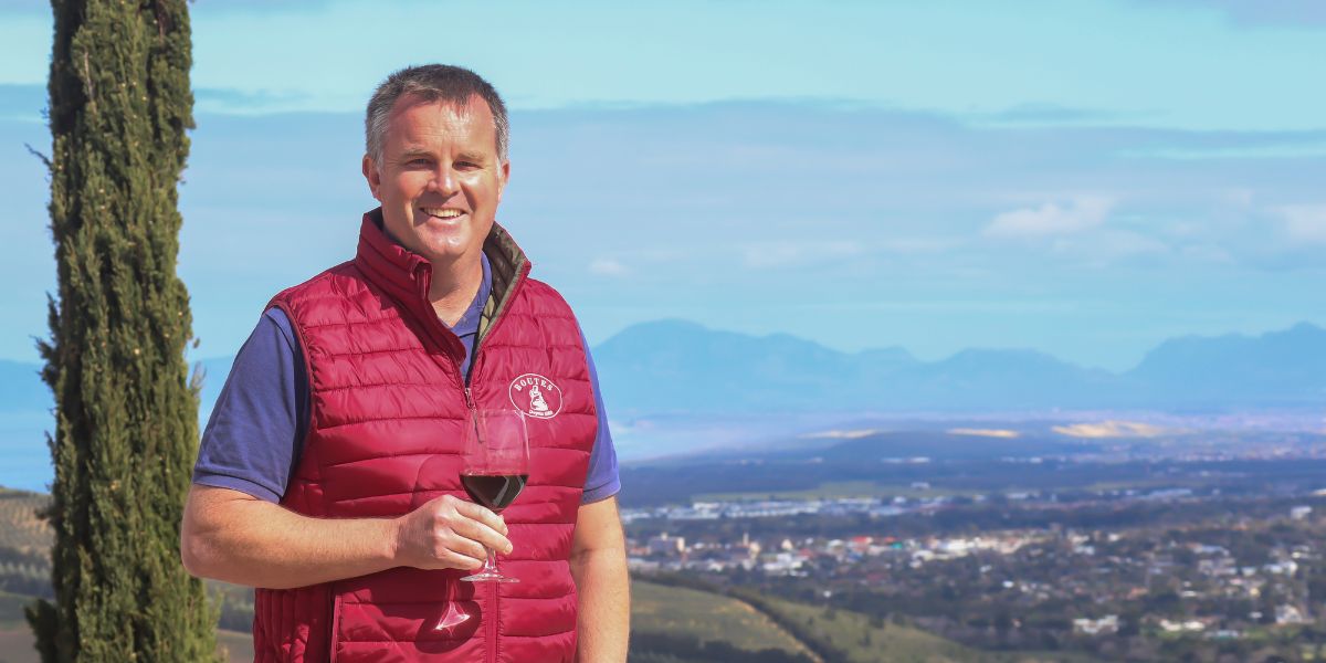 winemaker luke o'cuinneagain with glass of red wine at viewpoint
