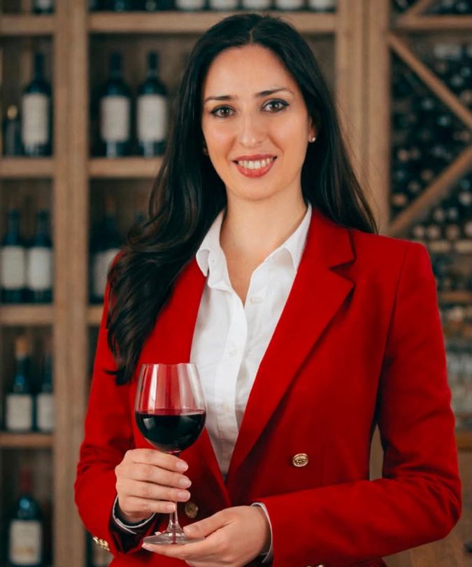 Winemaker Tamta Aivazashvili posing with glass of red wine