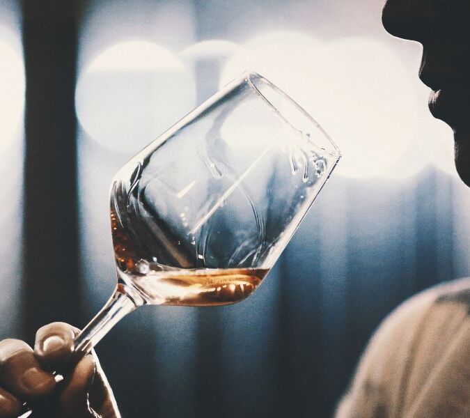drinker sniffing wine in glass