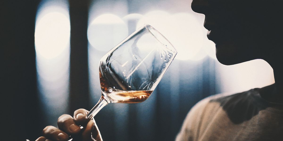 drinker sniffing wine in glass