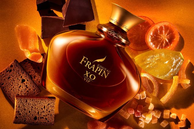 bottle of cognac frapin xo vip with ingredients to symbolise aromas
