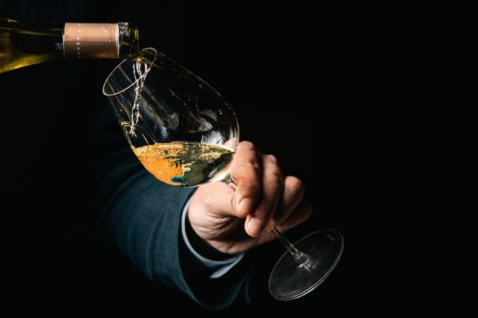 sommelier pouring wine into glass at beaufort bar