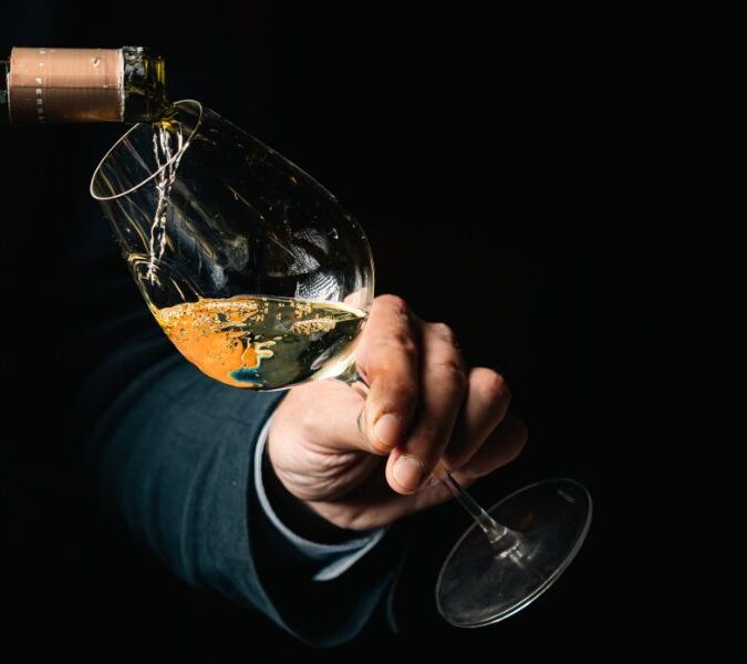 sommelier pouring wine into glass at beaufort bar